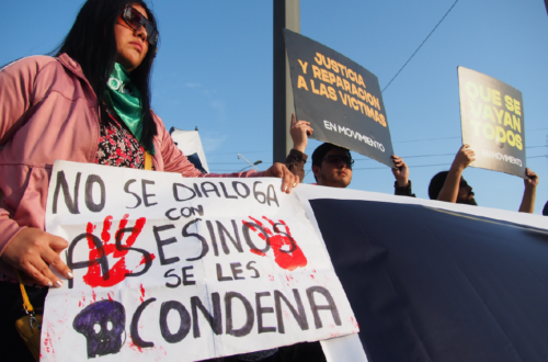 Demonstrator holding a protest sign with the message 