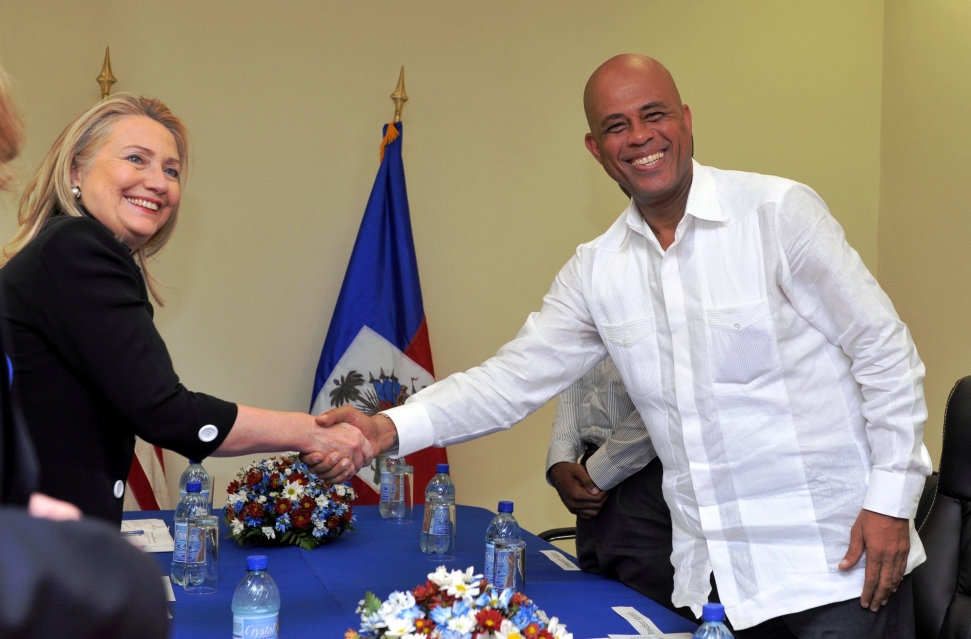 U.S. Secretary of State Hillary Rodham Clinton and Haitian President Michel Martelly shake hands at the beginning of their bilateral meeting at Caracol Industrial Park in Haiti [Photo copyright Kendra Helmer/USAID.