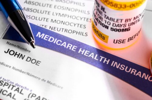 A close-up image showcases a Medicare Advantage health insurance card labeled John Doe, accompanied by a pen and a prescription pill bottle. The card features medical information in both English and Spanish, highlighting a focus on healthcare and medication management.