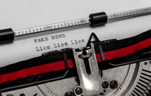 Close-up of a typewriter with a sheet of paper showing the text 