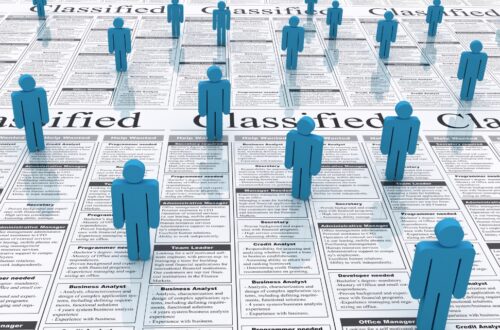 Blue 3D human figures stand on various newspaper classifieds, symbolizing eager job seekers exploring career opportunities. This scene serves as a November jobs preview.