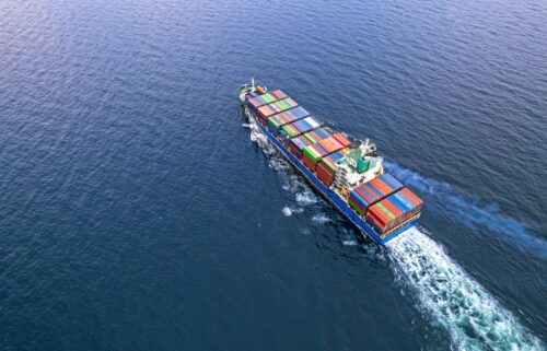 A cargo ship sails the trade routes on the water.