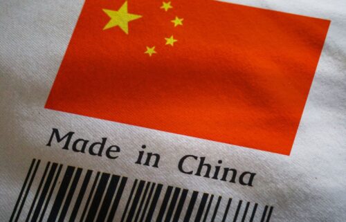 A fabric label displays the flag of China with its red background and five yellow stars. Below the flag, the text reads Made in China above a black barcode.