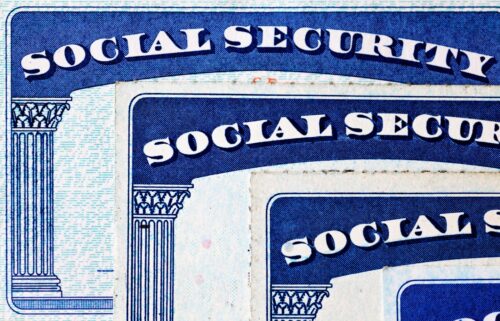 Social Security cards from different time periods laid on to of each other.