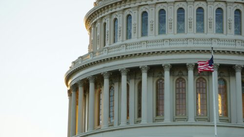 An American flag flies in the wind on the Capitol Building in Washington D.C. - Photo: ian-hutchinson