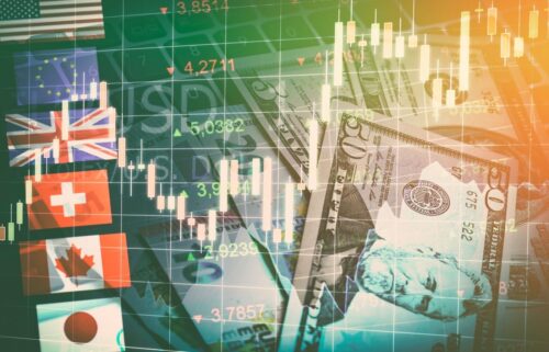 Composite image of global currency symbols, flags, and a fluctuating stock chart overlaid with US dollar bills, conveying a financial market theme.