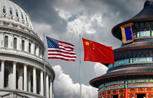The image shows the U.S. Capitol dome beside China's Temple of Heaven under a cloudy sky. The American and Chinese flags are prominently displayed between them.