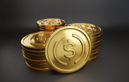 Stacks of shiny golden stablecoins with dollar signs, set against a dark background, conveying wealth and prosperity. The mood is rich and opulent.