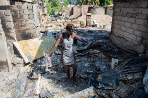A woman looks through the burned remains of her home the Solino district in Port-au-Prince on November 16, 2024, a day after gangs took over the area. On November 13, 2024, the Solino neighborhood fell under the control of the 