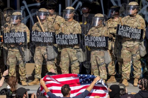 LOS ANGELES, CALIFORNIA - JUNE 09: Protesters confront California National Guard soldiers and police outside of a federal building as protests continue in Los Angeles following three days of clashes with police after a series of immigration raids on June 09, 2025 in Los Angeles, California. Tensions in the city remain high after the Trump administration called in the National Guard against the wishes of city leaders. (Photo by David McNew/Getty Images)