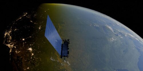 A Starlink satellite with large solar panels orbits Earth, capturing a view of the planet's curve. Night city lights glow on one side, contrasting with daylight.