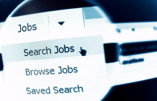 Close-up of a computer screen displaying a job search menu. A cursor points at 