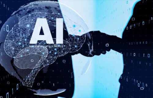 Digital illustration featuring a handshake silhouetted against a blue background with binary code. A neural network overlay surrounds the letters “AI,” symbolizing artificial intelligence and cooperation.