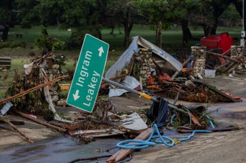 HUNT, TEXAS - JULY 6: A road sign lays among debris after flash flooding tore through the area on July 6, 2025 in Hunt, Texas. Heavy rainfall caused flooding along the Guadalupe River in central Texas with multiple fatalities reported. (Photo by Jim Vondruska/Getty Images)
