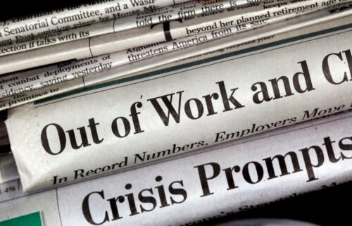 Stack of newspapers with large headlines about jobs, 