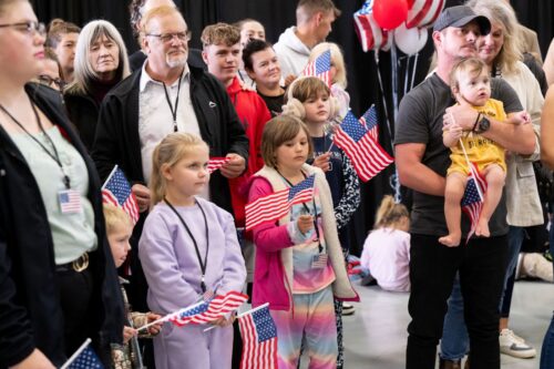The first group of Afrikaners from South Africa to arrive for resettlement listen to remarks from US Deputy Secretary of State Christopher Landau and US Deputy Secretary of Homeland Security Troy Edgar (both out of frame), after they arrived at Washington Dulles International Airport in Dulles, Virginia, on May 12, 2025. President Donald Trump on Monday defended the decision to resettle a group of white Afrikaners in the United States as refugees, saying they were fleeing a 