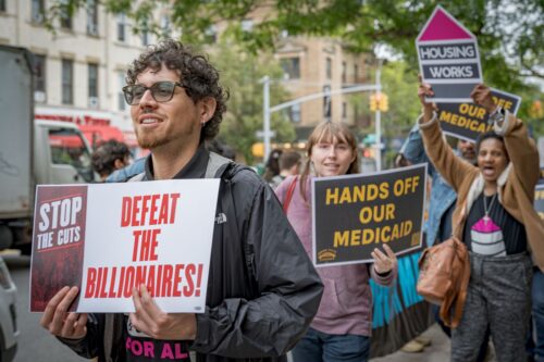 BROOKLYN, NEW YORK, UNITED STATES - 2025/05/29: Participants seen holding signs at the protest. New Yorkers gathered outside House Representative Nicole Malliotakis office in Bay Ridge, Brooklyn to protest her decision to vote in favor to pass the so called Big Beautiful Bill, a bill that contains severe cuts to social services like healthcare, housing and food assistance federally funded programs and big tax cuts to billionaires and big corporations. (Photo by Erik McGregor/LightRocket via Getty Images)
