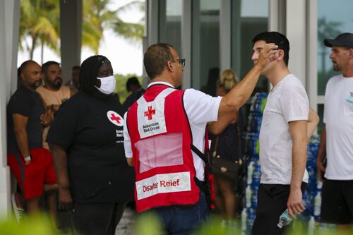 SURFSIDE, FLORIDA, USA - JUNE 24: American Red Cross workers speak to people at Surfside Community Center after 12-storey Champlain Tower partially collapsed in Surfside, Florida, U.S., on June 24, 2021. (Photo by Eva Marie Uzcategui Trinkl/Anadolu Agency via Getty Images)