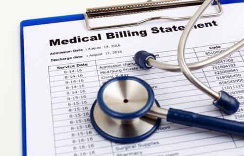 A blue stethoscope rests on a medical billing statement clipboard, displaying service dates and charges, and highlighting rising healthcare costs.