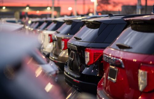 Row of SUVs in various colors parked at a dealership, with a warm sunset in the background creating a serene ambiance.