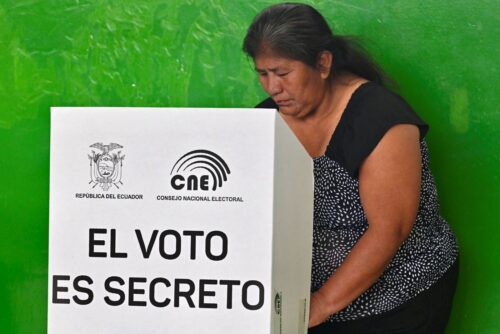 A woman casts her vote during the referendum, in Manglaralto, Santa Elena province, Ecuador on November 16, 2025. Ecuadoreans are voting in a referendum proposed by President Daniel Noboa on whether to allow the return of foreign military bases, draft a new constitution that could expand presidential powers, eliminate public funding for political parties, and reduce the number of lawmakers. (Photo by MARCOS PIN / AFP) (Photo by MARCOS PIN/AFP via Getty Images)