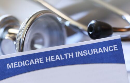 A close-up of a Medicare health insurance document with a blue header next to a stethoscope, symbolizing healthcare and insurance coverage.