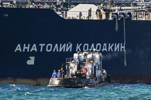Workers on a tugboat guide the Russian oil tanker Anatoly Kolodkin as it arrives at the oil terminal in the port of Matanzas, northwestern Cuba, on March 31, 2026. The Anatoly Kolodkin, a tanker under US sanctions carrying 730,000 barrels of crude, is set to deliver the first crude shipment to Cuba since January after Washington gave the crisis-hit island a reprieve from an effective fuel blockade. (Photo by Yamil LAGE / AFP via Getty Images)