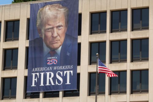 WASHINGTON, DC - MAY 30: A banner with a portrait of U.S. President Donald Trump is displayed on the front U.S. Department of Labor Frances Perkins Building on May 30, 2026 in Washington, DC. (Photo by Kevin Carter/Getty Images)