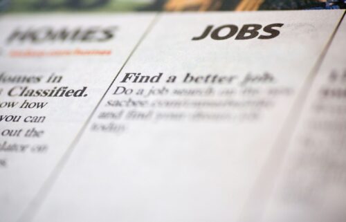Blurred image of a newspaper classified section featuring 