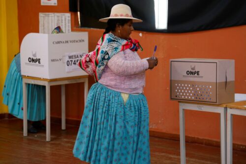 Indigenous women prepare to cast their vote during the presidential election at a polling station in Capachica, province of Puno, Peru, on April 12, 2026. Peruvians will elect a new president from a record field of 35 candidates to lead a country plagued by organized crime and chronic political instability. (Photo by Juan Carlos CISNEROS / AFP via Getty Images)