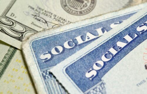 Social security cards displayed with various denominations of money, representing personal finance and identification.